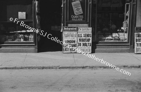 SHOP WITH NEWSPAPER ADS OUTSIDE